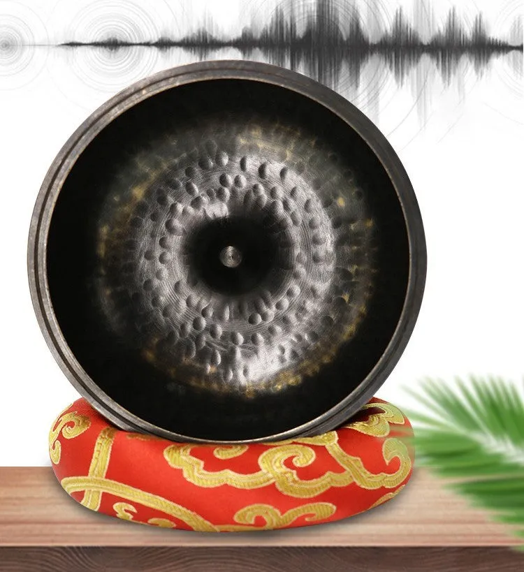 Black and gold copper sound bowl with Buddha design on thin pad, 12.5cm calibre