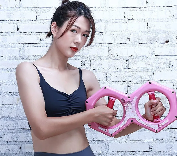 Black ABS figure 8 wrist power machine grip trainer on desk