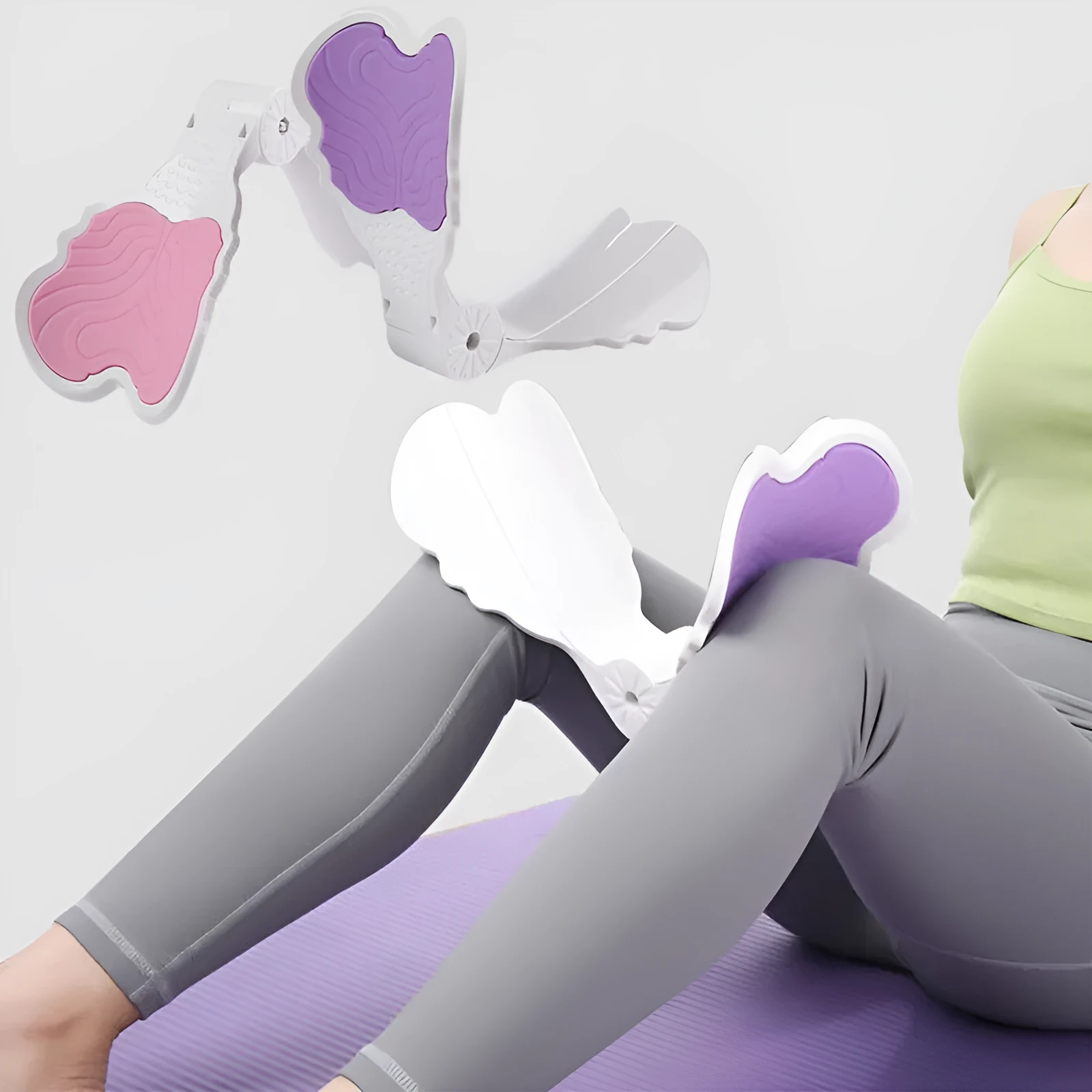 Pink hip trainer with silicone surface measuring 27cm by 9.5cm for pelvic floor and inner thigh exercises
