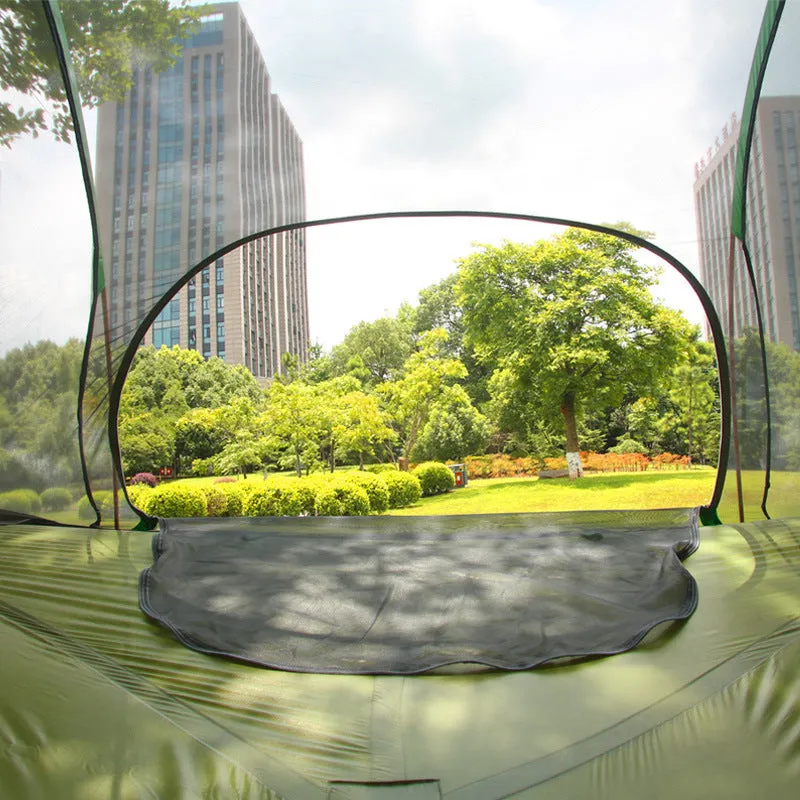 Self-driving tour camping hammock tent with aluminium pole and mosquito net suspended between trees in a forest setting