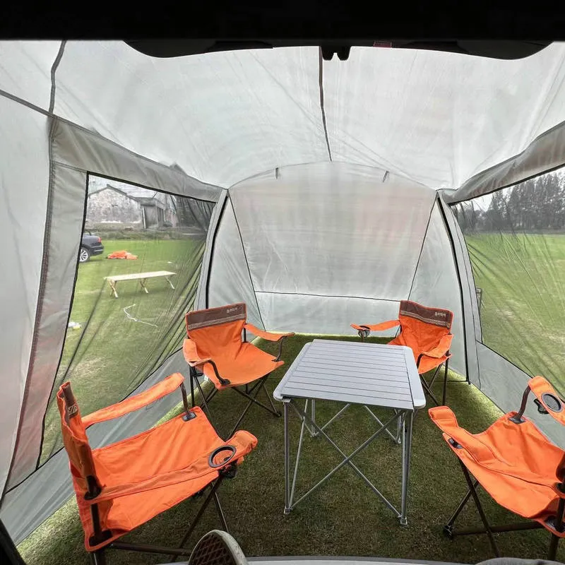 Car tail extension tent set up at a campsite with rear access, showing 190T silver-coated anti-UV fabric and screen windows.