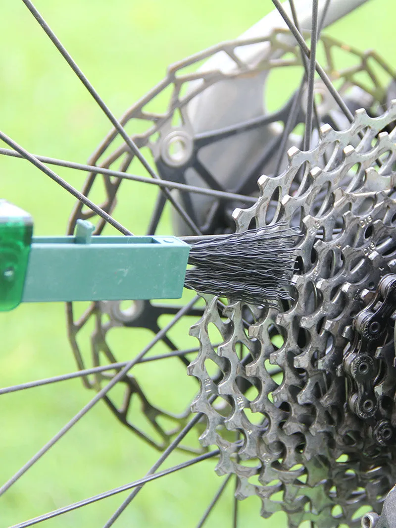 Bicycle chain cleaner scrubber brush set with PC plastic housing, soft brush, and three wear-resistant sponges on a workbench