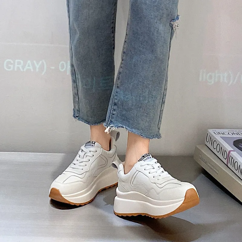 Women's beige cattlehide leather low-top casual sports shoes with cross strap and round toe.