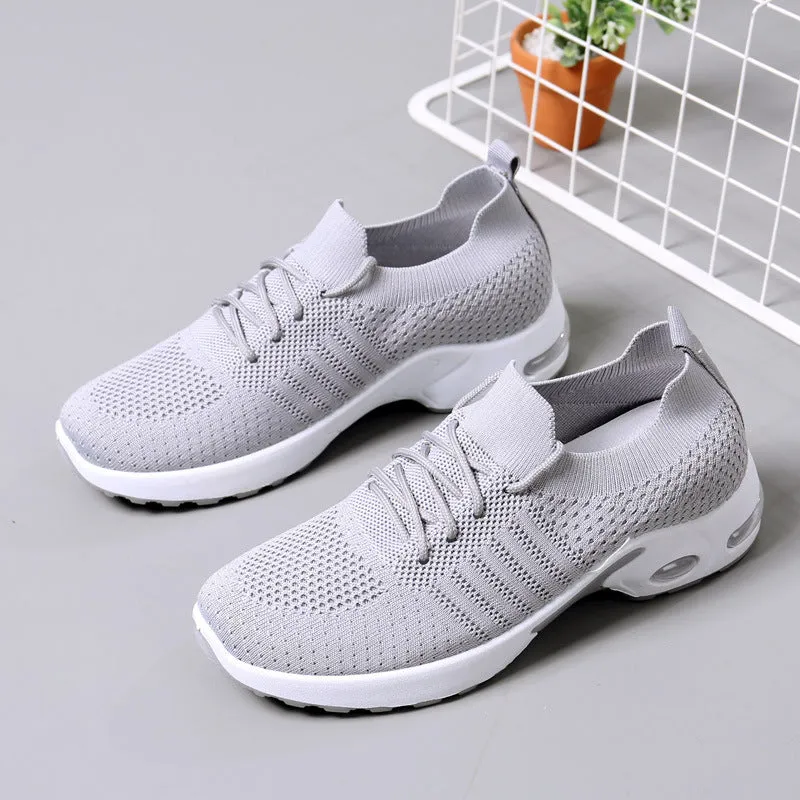 Women's solid-colour mesh sneaker with lace-up front and round toe, shown in grey.