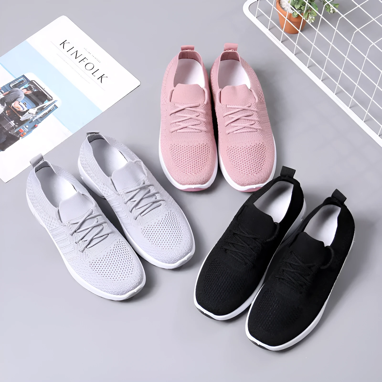 Women's solid-colour mesh sneaker with lace-up front and round toe, shown in grey.