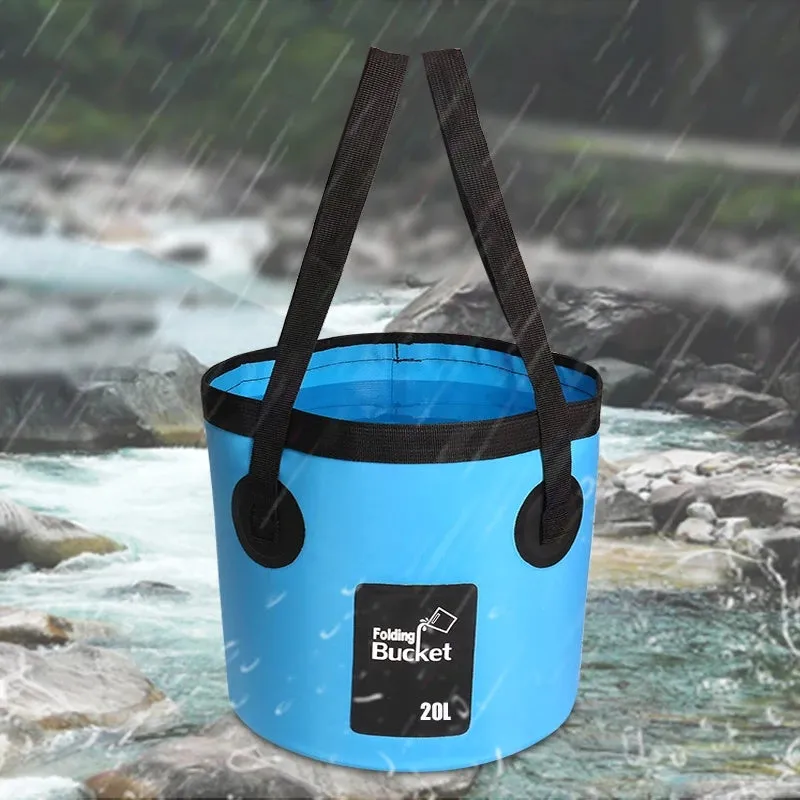 Yellow 20L folding PVC tarpaulin bucket open and standing on grass with water inside