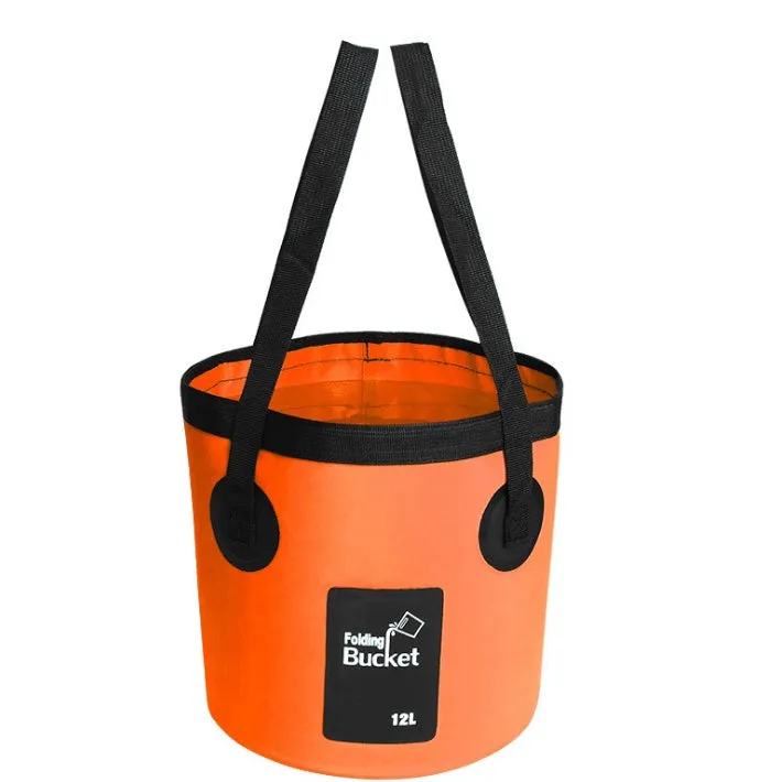 Yellow 20L folding PVC tarpaulin bucket open and standing on grass with water inside