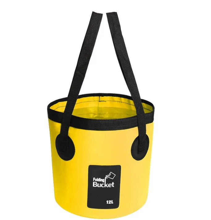 Yellow 20L folding PVC tarpaulin bucket open and standing on grass with water inside