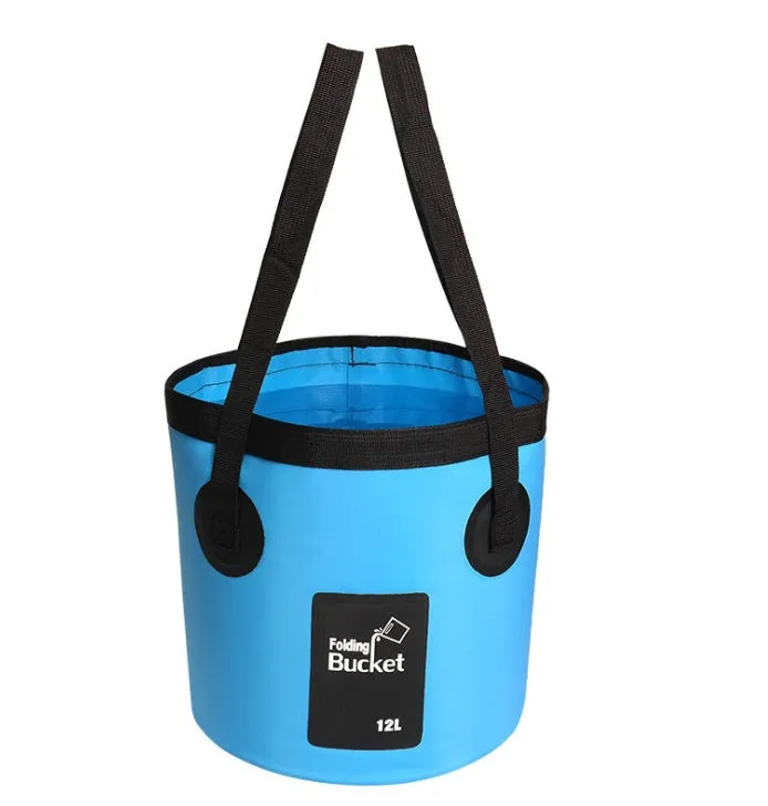 Yellow 20L folding PVC tarpaulin bucket open and standing on grass with water inside
