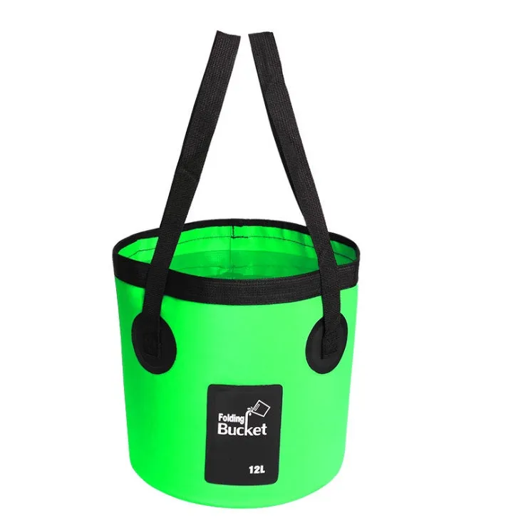 Yellow 20L folding PVC tarpaulin bucket open and standing on grass with water inside