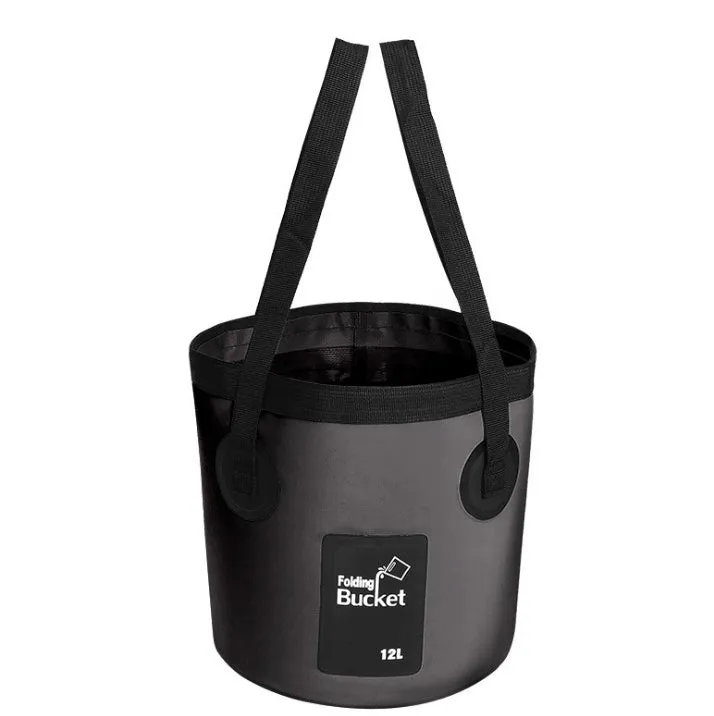 Yellow 20L folding PVC tarpaulin bucket open and standing on grass with water inside