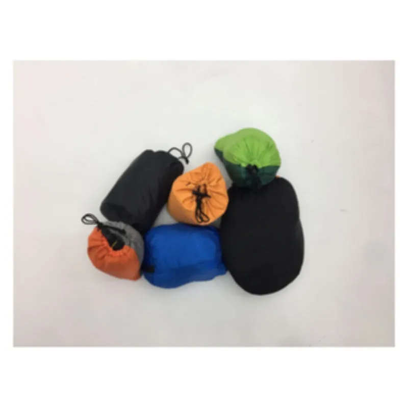 Automatic quick-opening double hammock with mosquito net and sun shades in Army Green Orange set up between trees outdoors