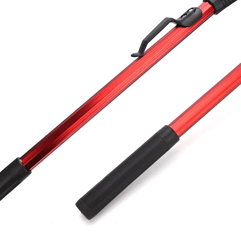 Red aluminium alloy single section triangular folding dip net collapsed to 47cm length, with viscose mesh, on a wooden table