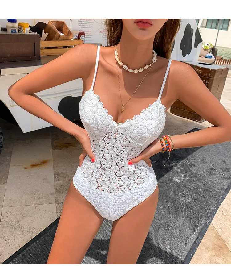Women's white embroidered knitted one-piece swimsuit with chest pad on plain background