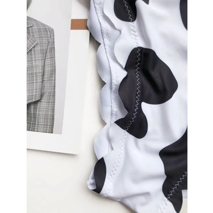 Black and white cow print wrapped breast bikini set on a model, nylon fabric, black and white animal pattern, adjustable wrap front top
