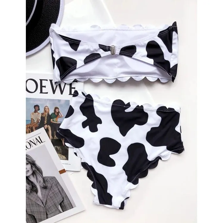 Black and white cow print wrapped breast bikini set on a model, nylon fabric, black and white animal pattern, adjustable wrap front top