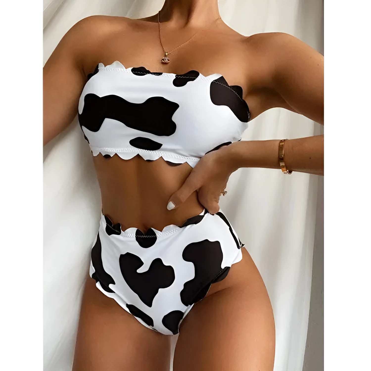 Black and white cow print wrapped breast bikini set on a model, nylon fabric, black and white animal pattern, adjustable wrap front top