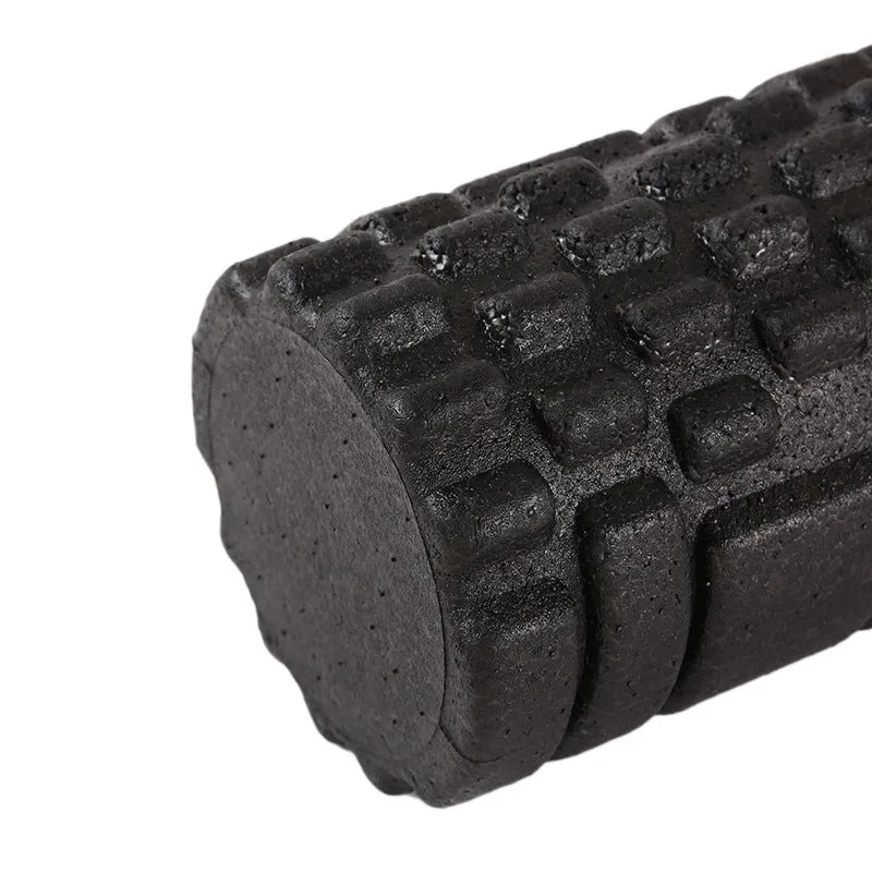 Hollow black EPP foam roller 33x14cm on flat surface for Pilates and balance exercises