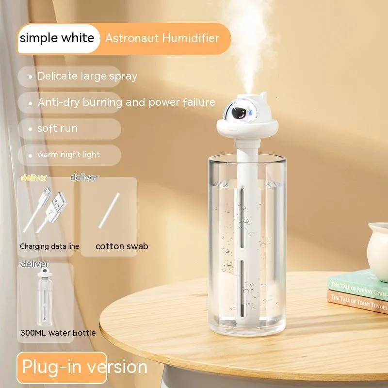 Small white plastic astronaut humidifier with USB cable on desk