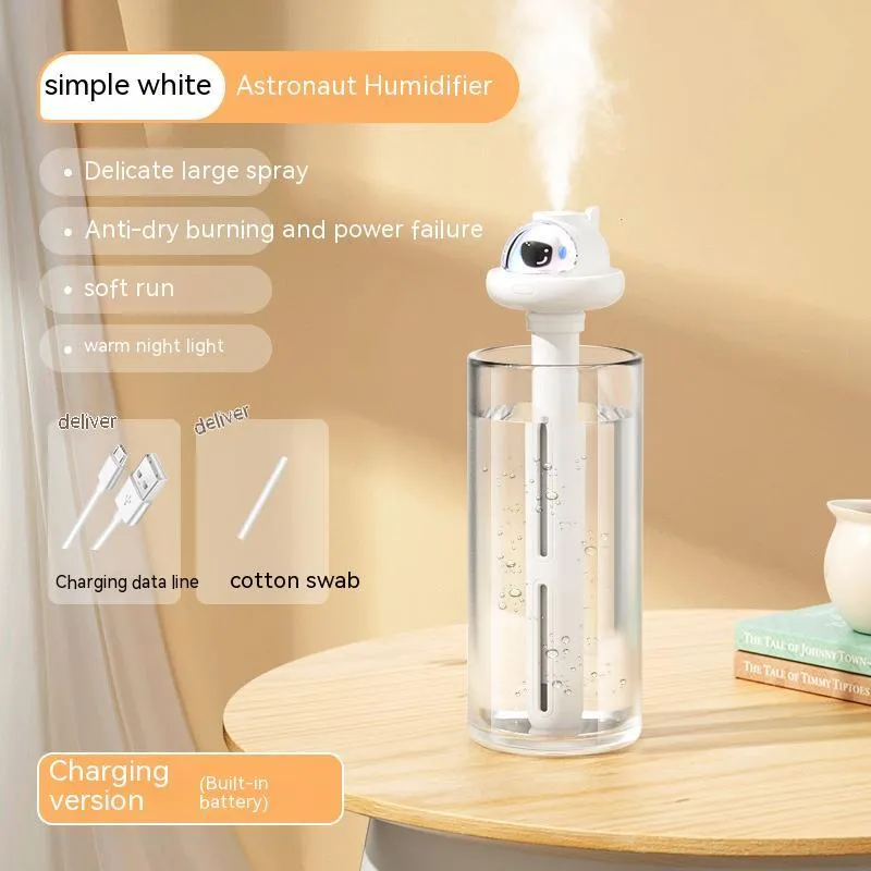 Small white plastic astronaut humidifier with USB cable on desk