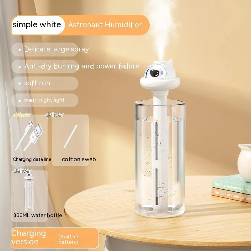 Small white plastic astronaut humidifier with USB cable on desk