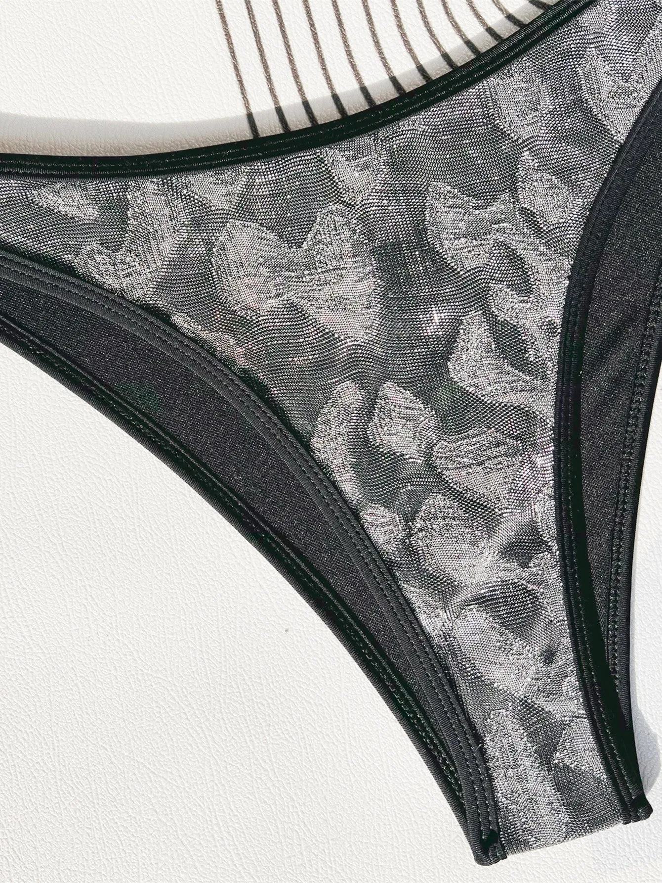 Women's black bikini set with strap design for swimming.