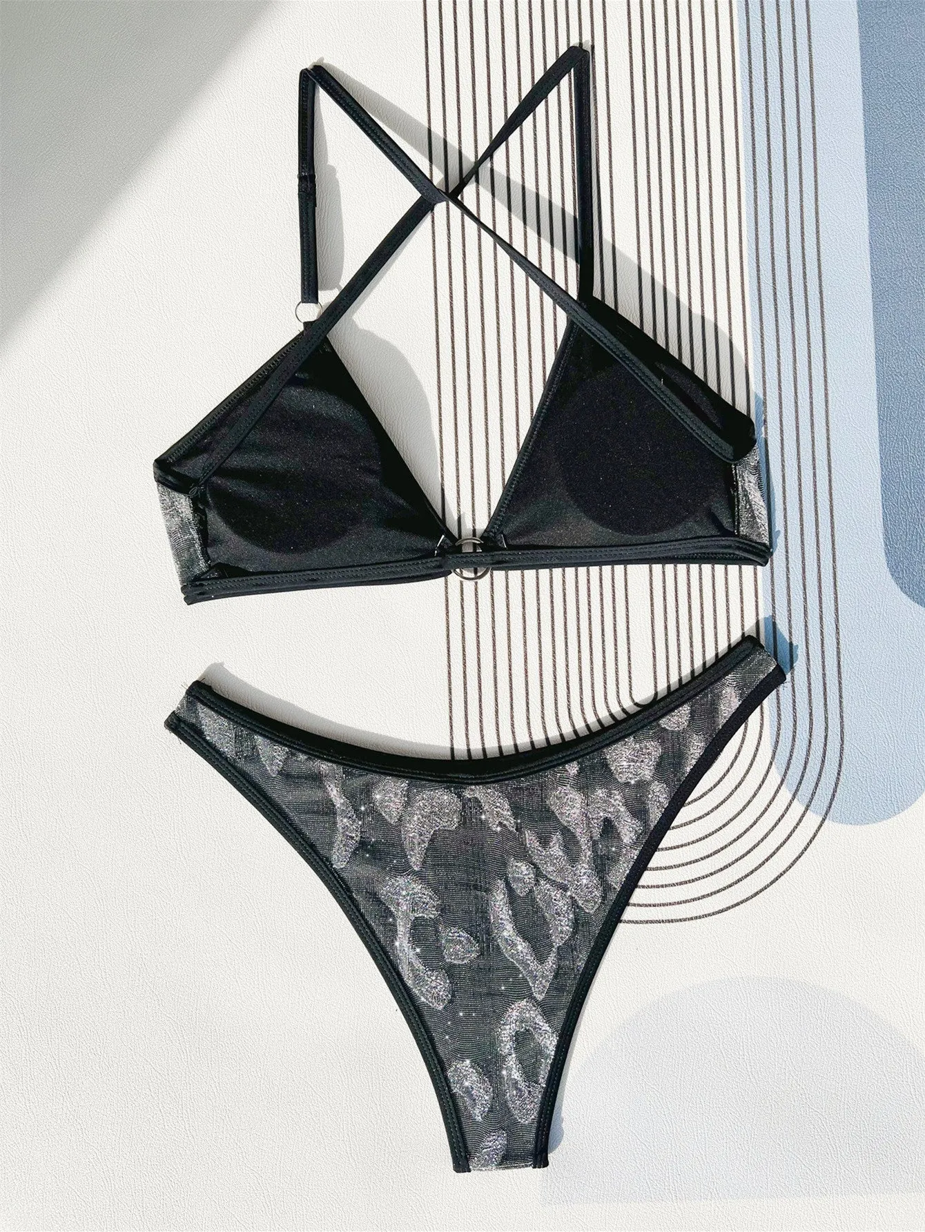 Women's black bikini set with strap design for swimming.