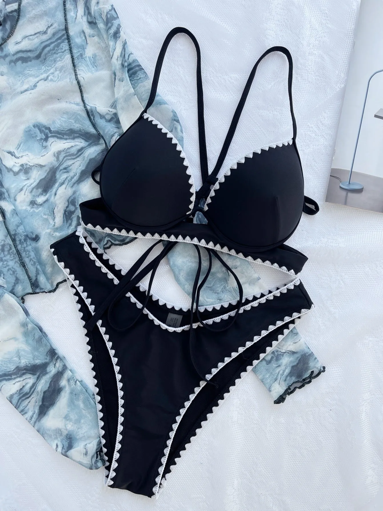 Women's black split bikini swimsuit made from nylon fabric, available in sizes S M L