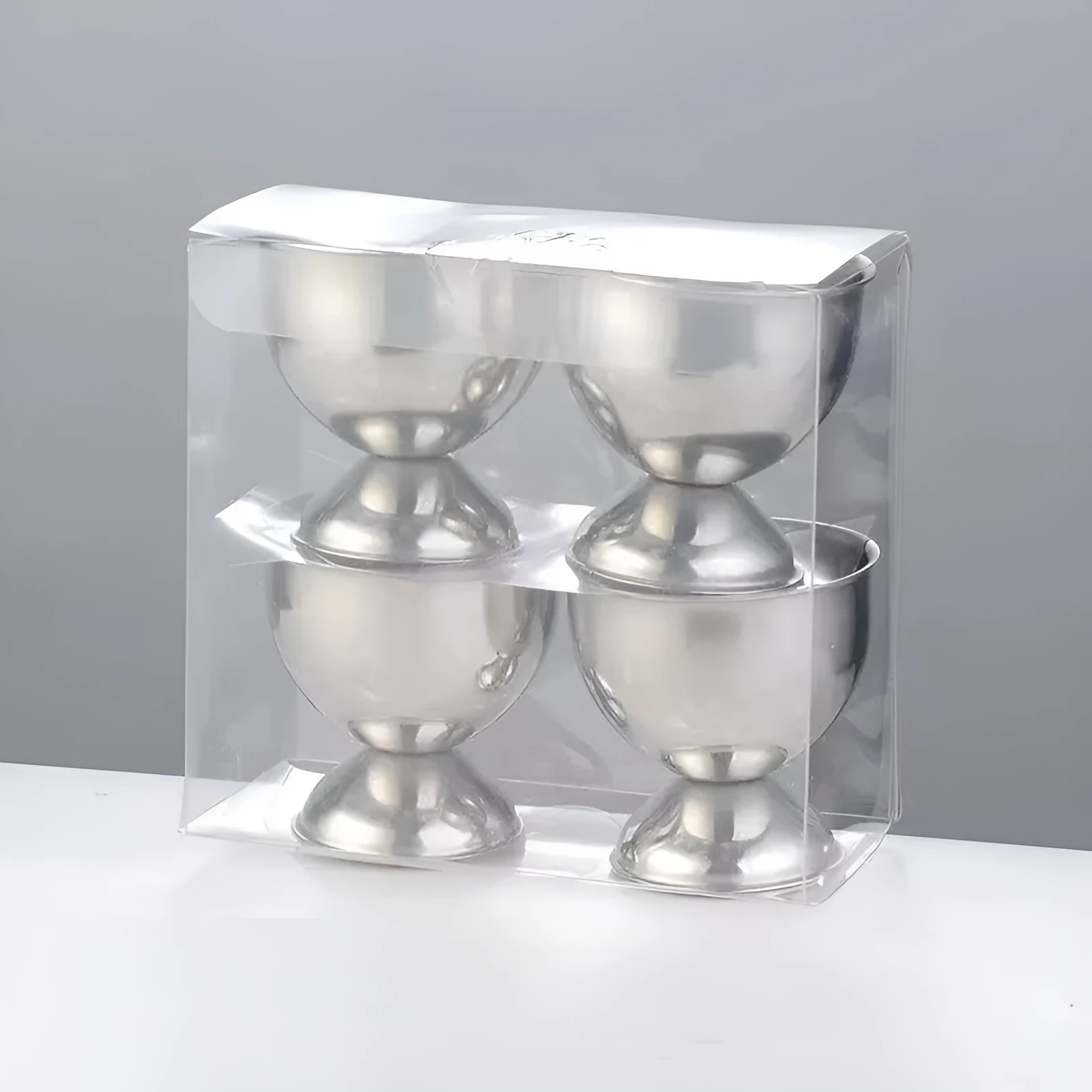 Creative stainless steel egg bracket in silver finish, holding eggs on a kitchen countertop.