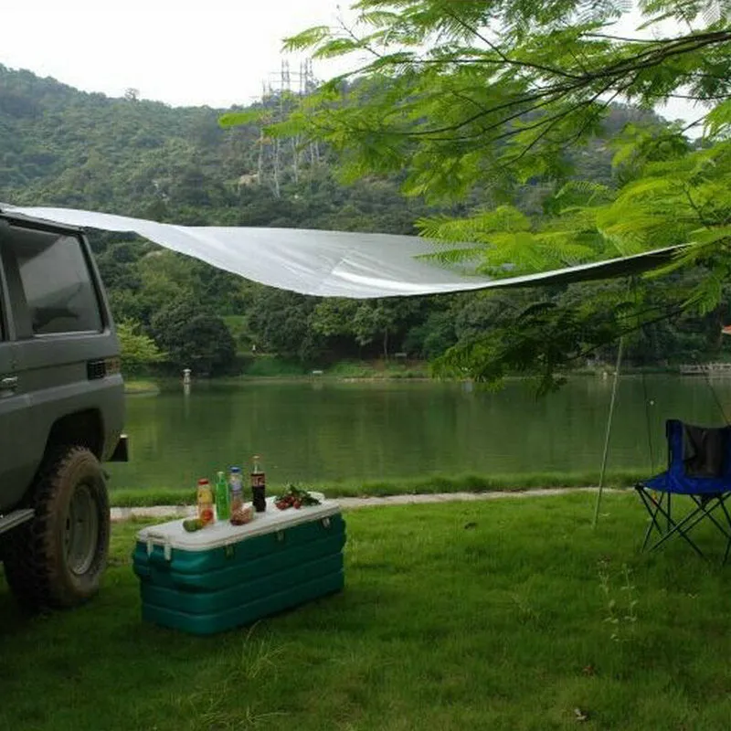 Green Unity car side awning set up next to a vehicle, showing the 2.8m x 1.8m double tent structure