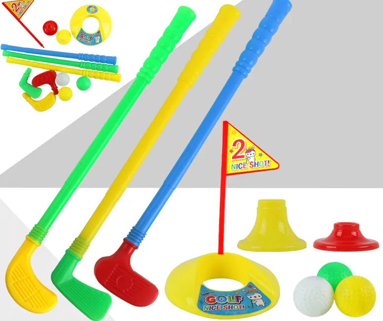 Children's golf set with three clubs, three balls, hole, flag, and tees on grass