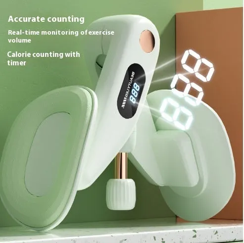Grey coloured pelvic floor muscle trainer with a counter display, held in hand.