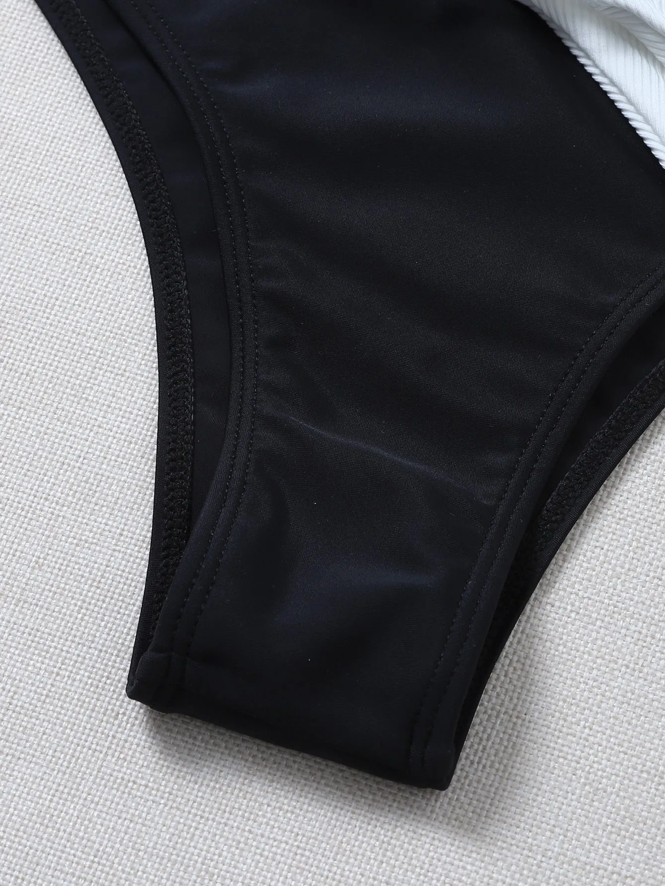 Solid colour bikini with chest pad in black and white, polyester fabric, front view