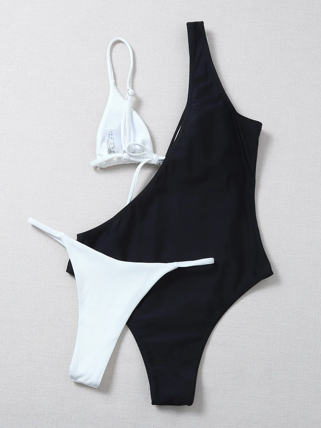 Solid colour bikini with chest pad in black and white, polyester fabric, front view