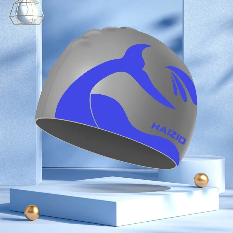 Silicone swimming cap with waterproof ear protectors showing whale tail pattern in assorted colours