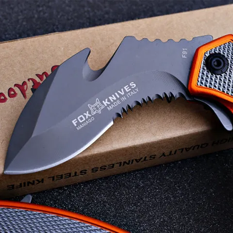 Orange folding knife with steel handle and 8.2cm blade open on outdoor surface showing total length and grip texture