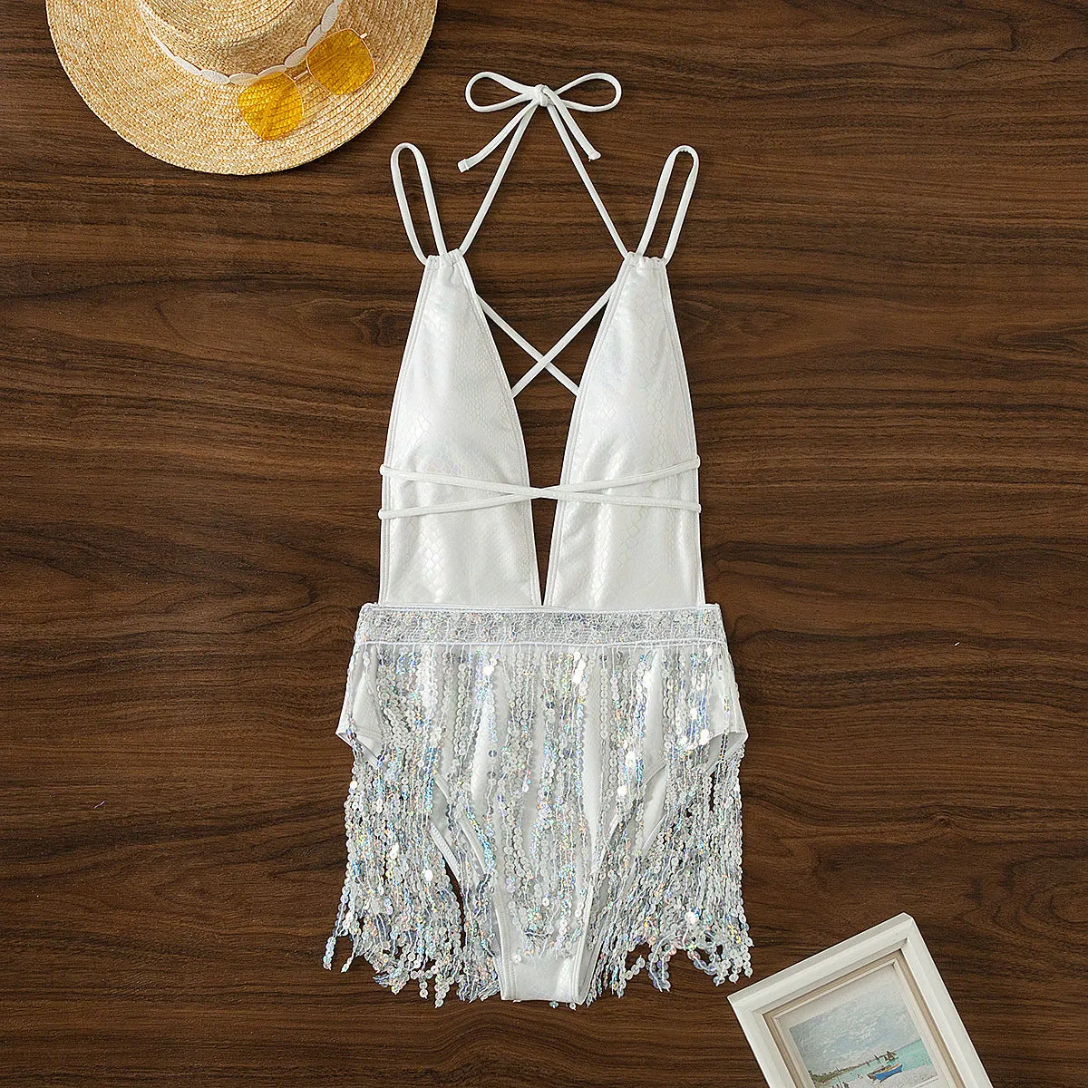 White women's one-piece swimsuit with deep V-neck and tassel details