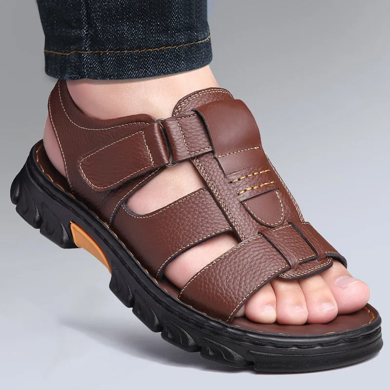 Men's brown cowhide leather sandals with velcro strap and open toe on a beach background