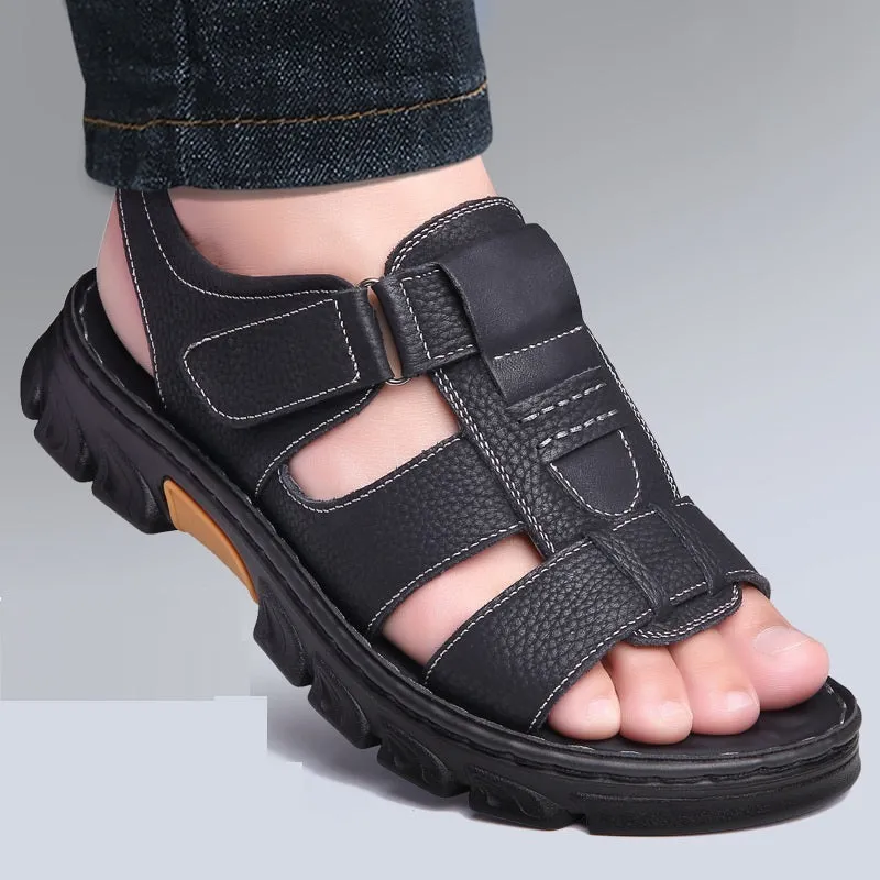 Men's brown cowhide leather sandals with velcro strap and open toe on a beach background