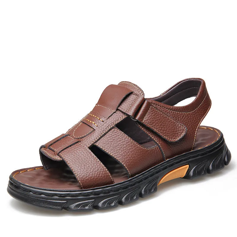 Men's brown cowhide leather sandals with velcro strap and open toe on a beach background