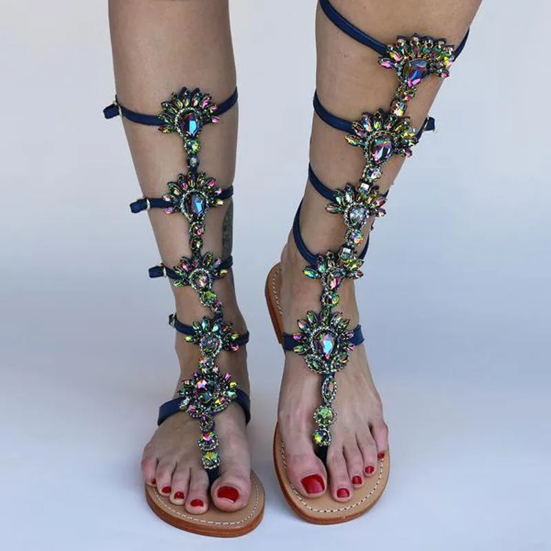 Women's flat roman sandals with rhinestone upper, round toe, in silver colour on plain background