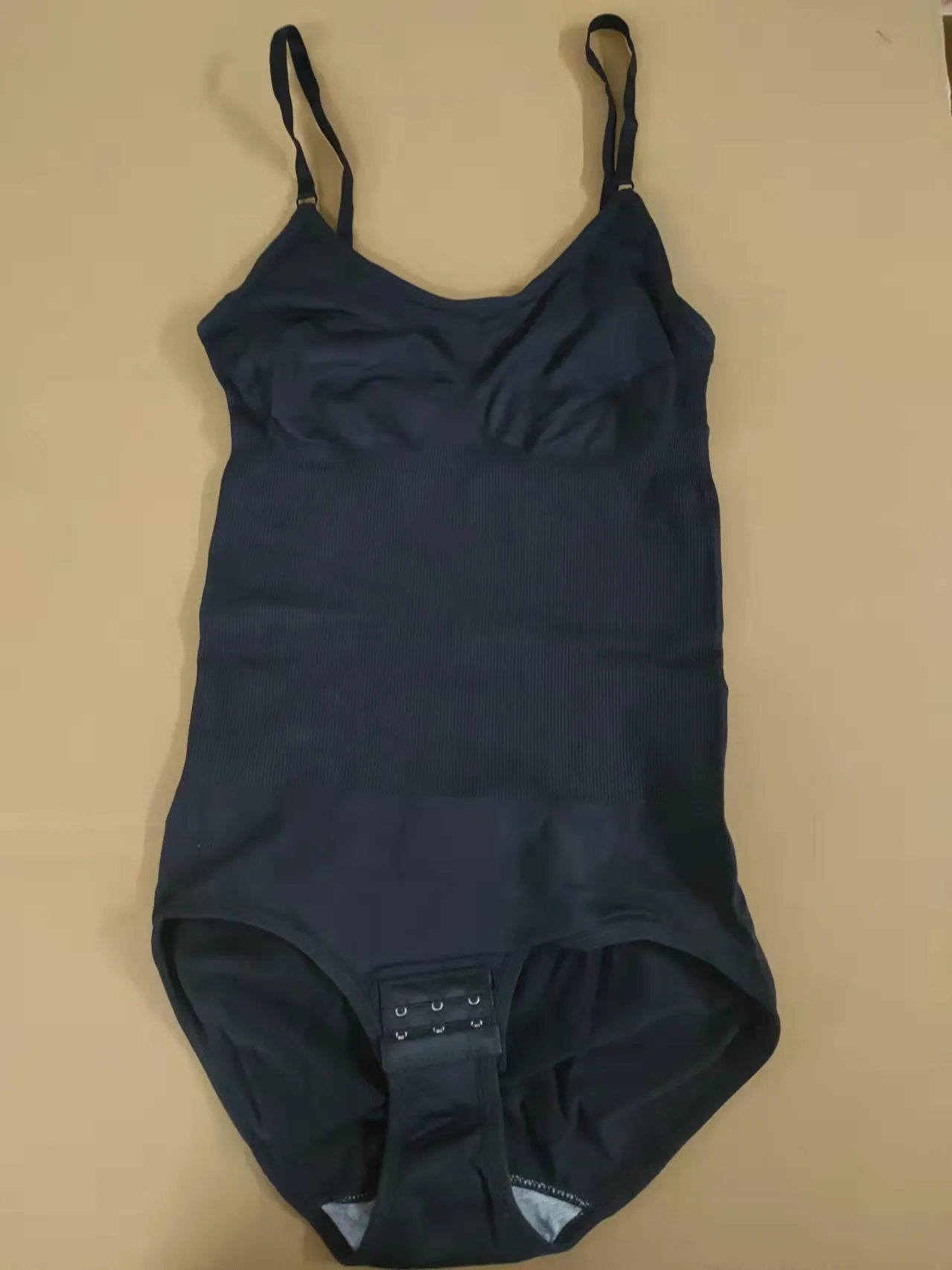 Plus size women's stretch nylon hip lift belly control sling body shaper in black, shown front view