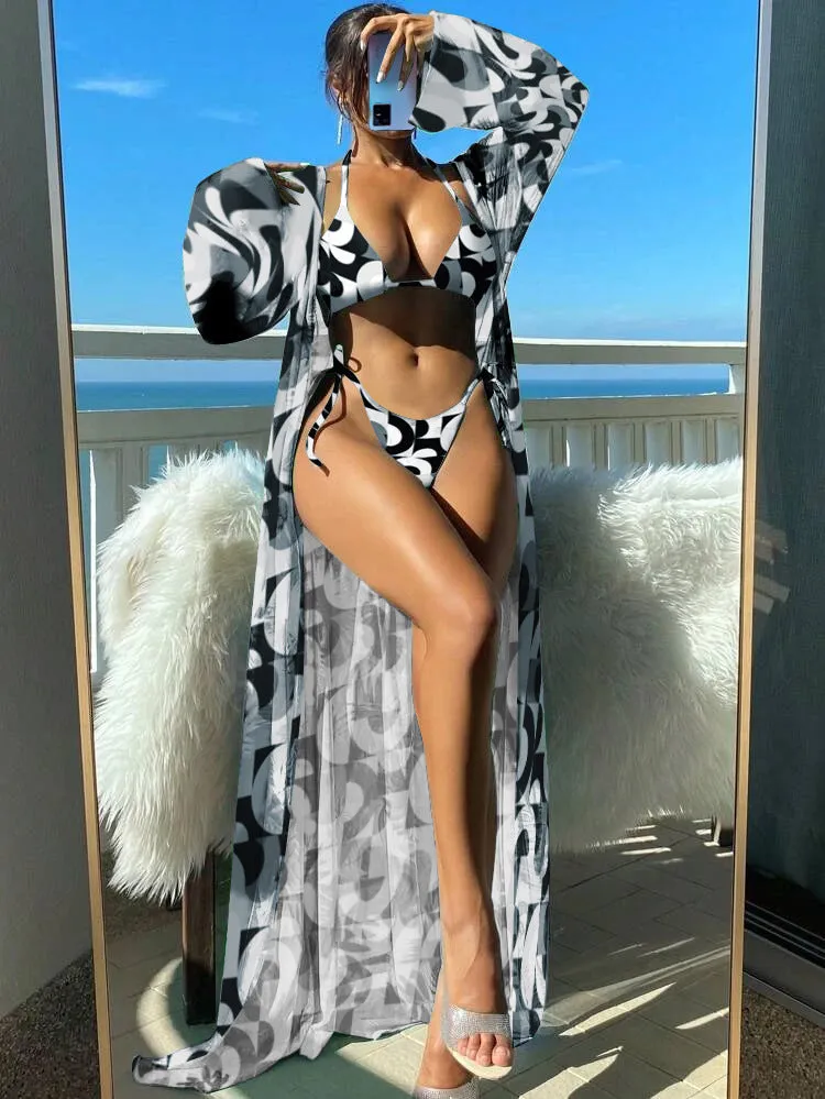 Blue long sleeve bikini set with banded briefs and a matching outer robe laid flat