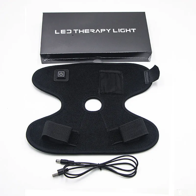 Black physical therapy ankle support with red light heat compress and USB cable