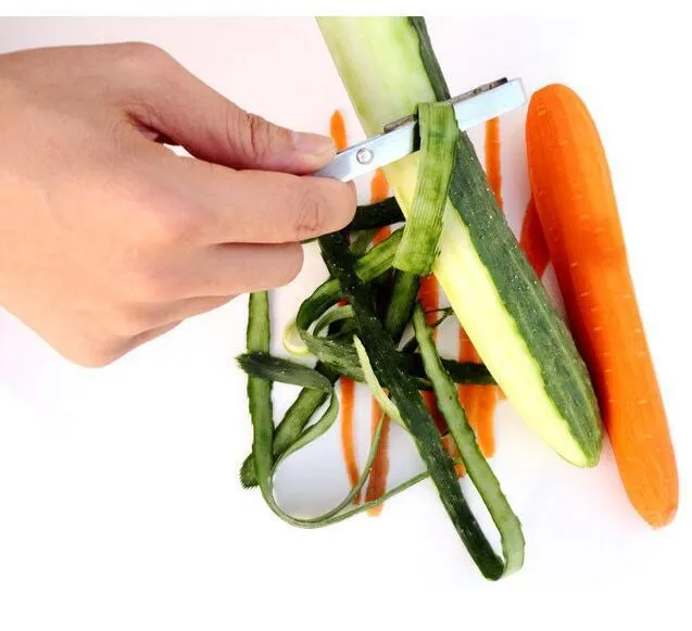 Silver stainless steel fruit and vegetable peeler on a clean kitchen counter
