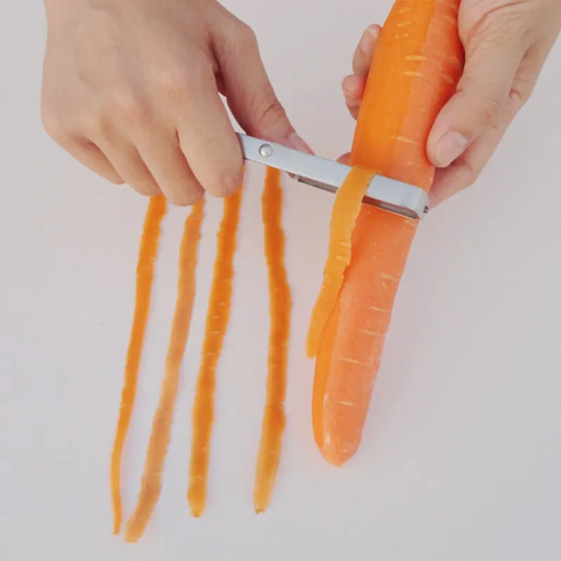 Silver stainless steel fruit and vegetable peeler on a clean kitchen counter