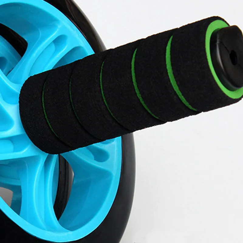 Green two-wheel abdominal wheel roller with 14-inch kneeling mat on floor for home exercise