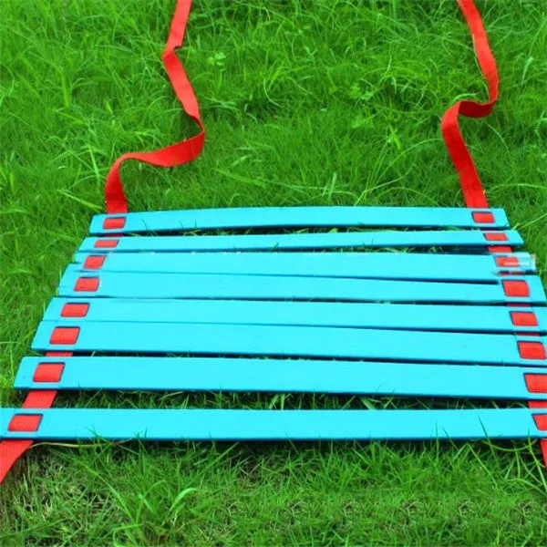 PP jump ladder in black laid flat on grass for foot basket training