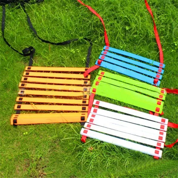 PP jump ladder in black laid flat on grass for foot basket training
