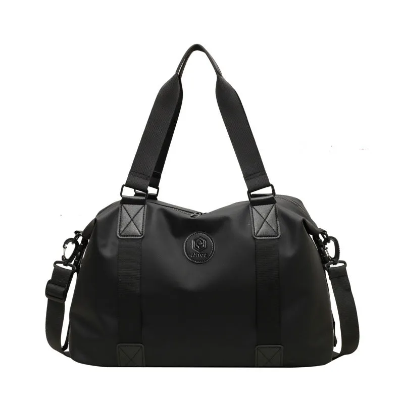 Large black waterproof Oxford cloth travel rucksack with multiple compartments shown on a grey background.